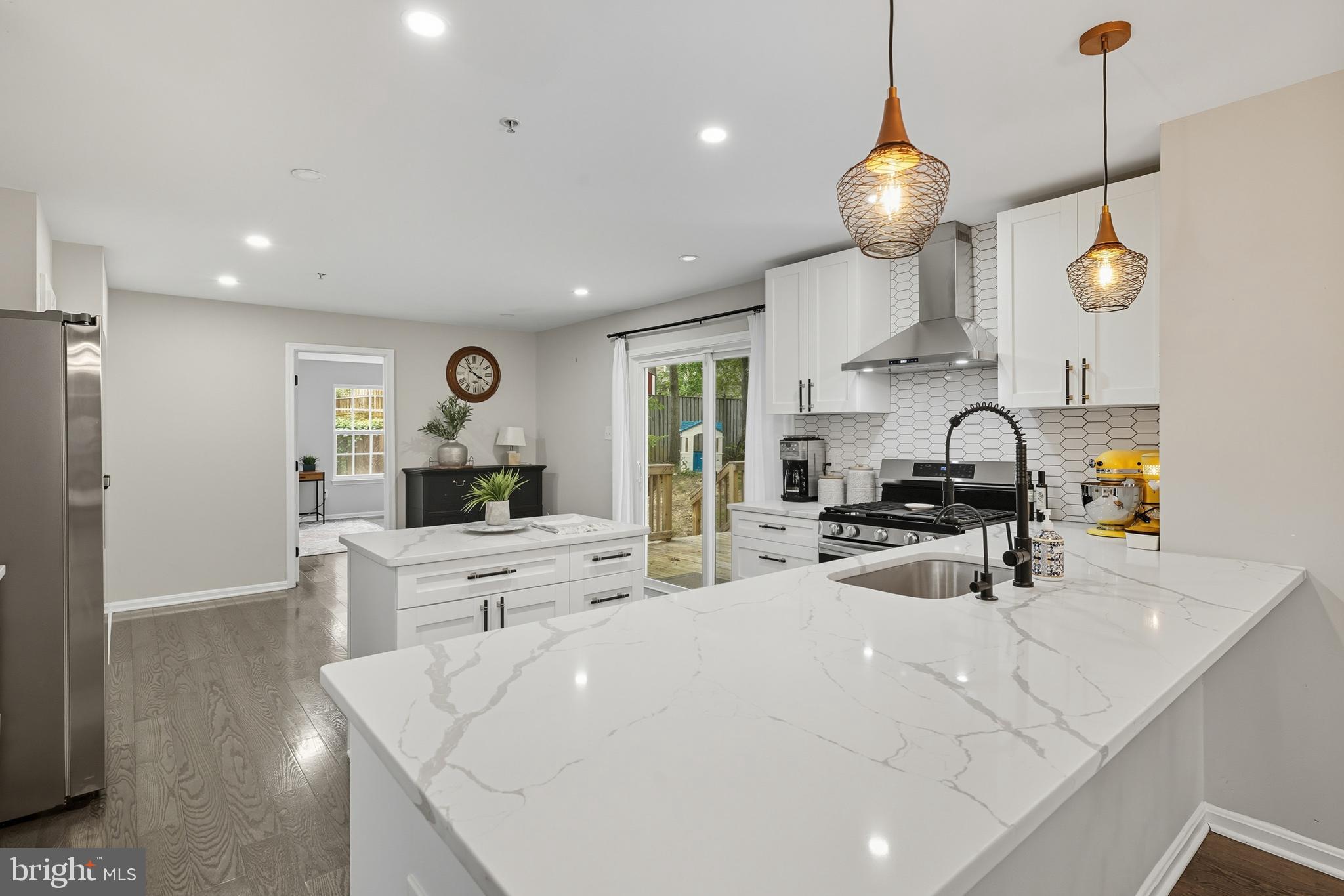 3100 Hillside Avenue Cheverly, MD 20785 - Photo 15 of 58 a large white kitchen with a large window and stainless steel appliances