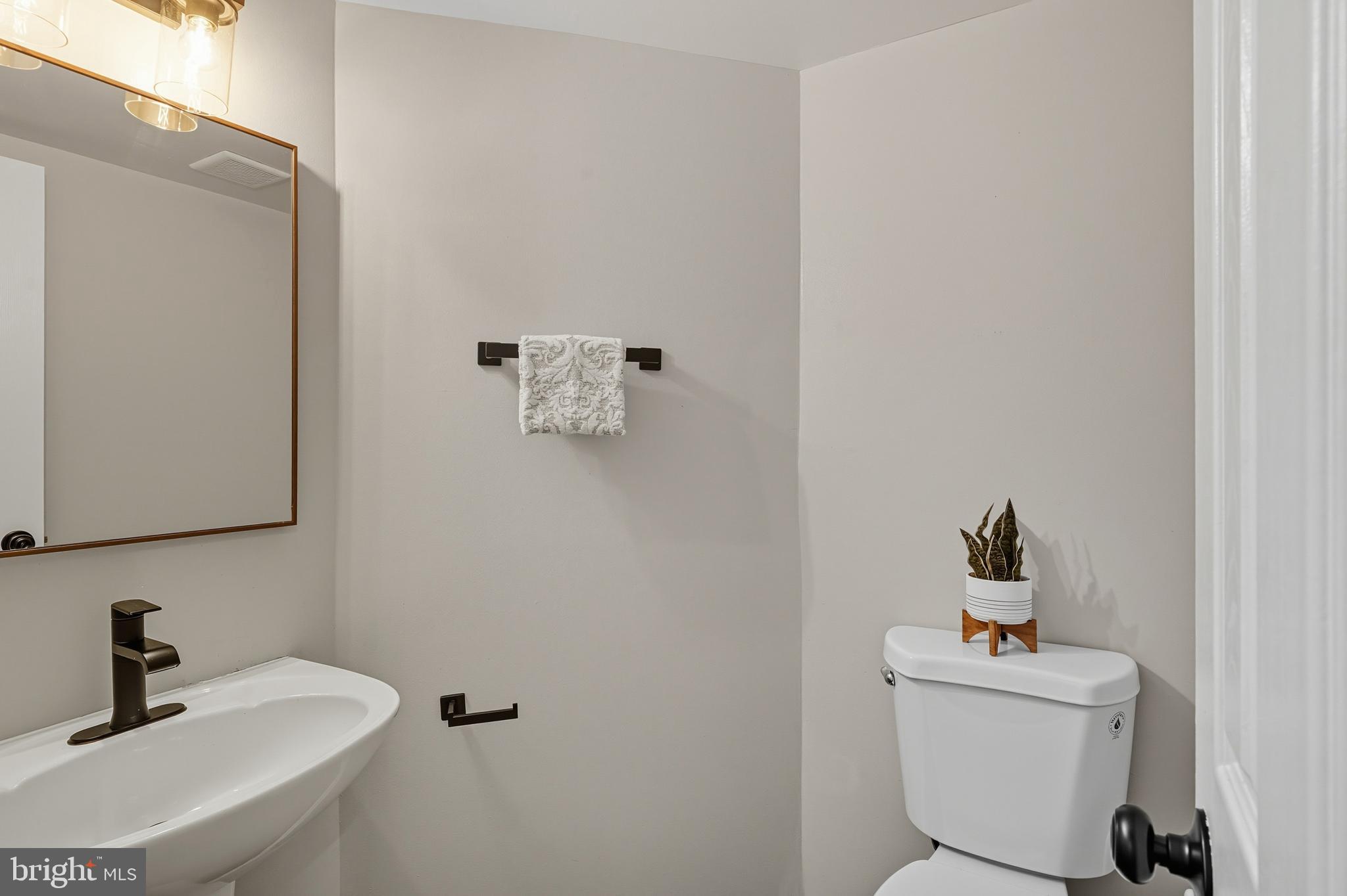 3100 Hillside Avenue Cheverly, MD 20785 - Photo 19 of 58 a bathroom with a sink toilet and a mirror