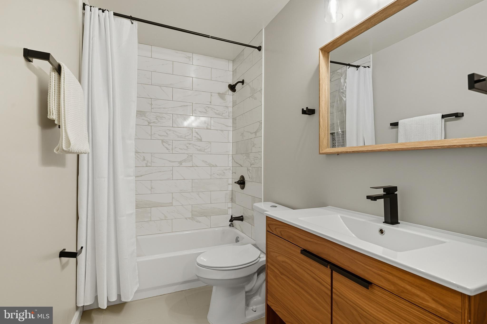 3100 Hillside Avenue Cheverly, MD 20785 - Photo 29 of 58 a bathroom with a sink a toilet and shower