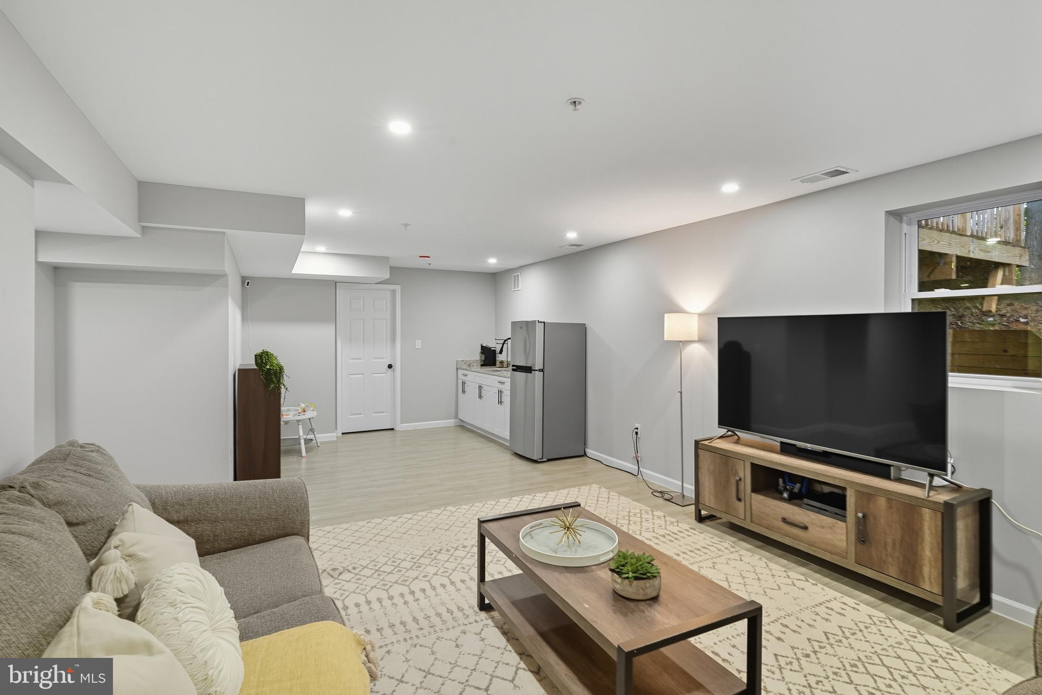 3100 Hillside Avenue Cheverly, MD 20785 - Photo 34 of 58 a living room with furniture and a flat screen tv