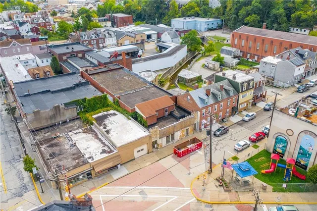 an aerial view of a swimming pool with outdoor seating and plants