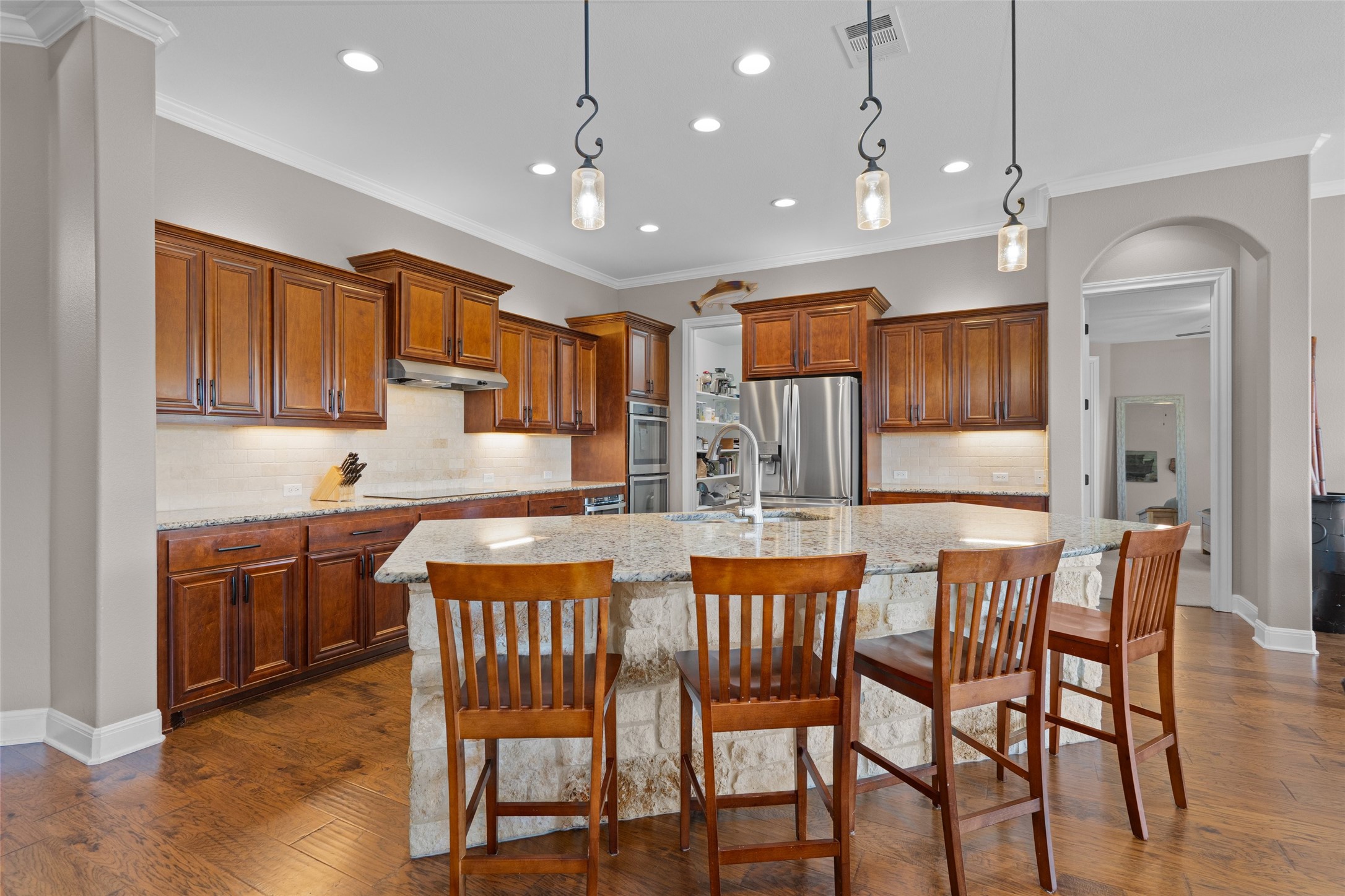 164 Milestone Road Liberty Hill, TX 78642 - Photo 12 of 40 Kitchen featuring a spacious island, breakfast bar, and lots of storage.