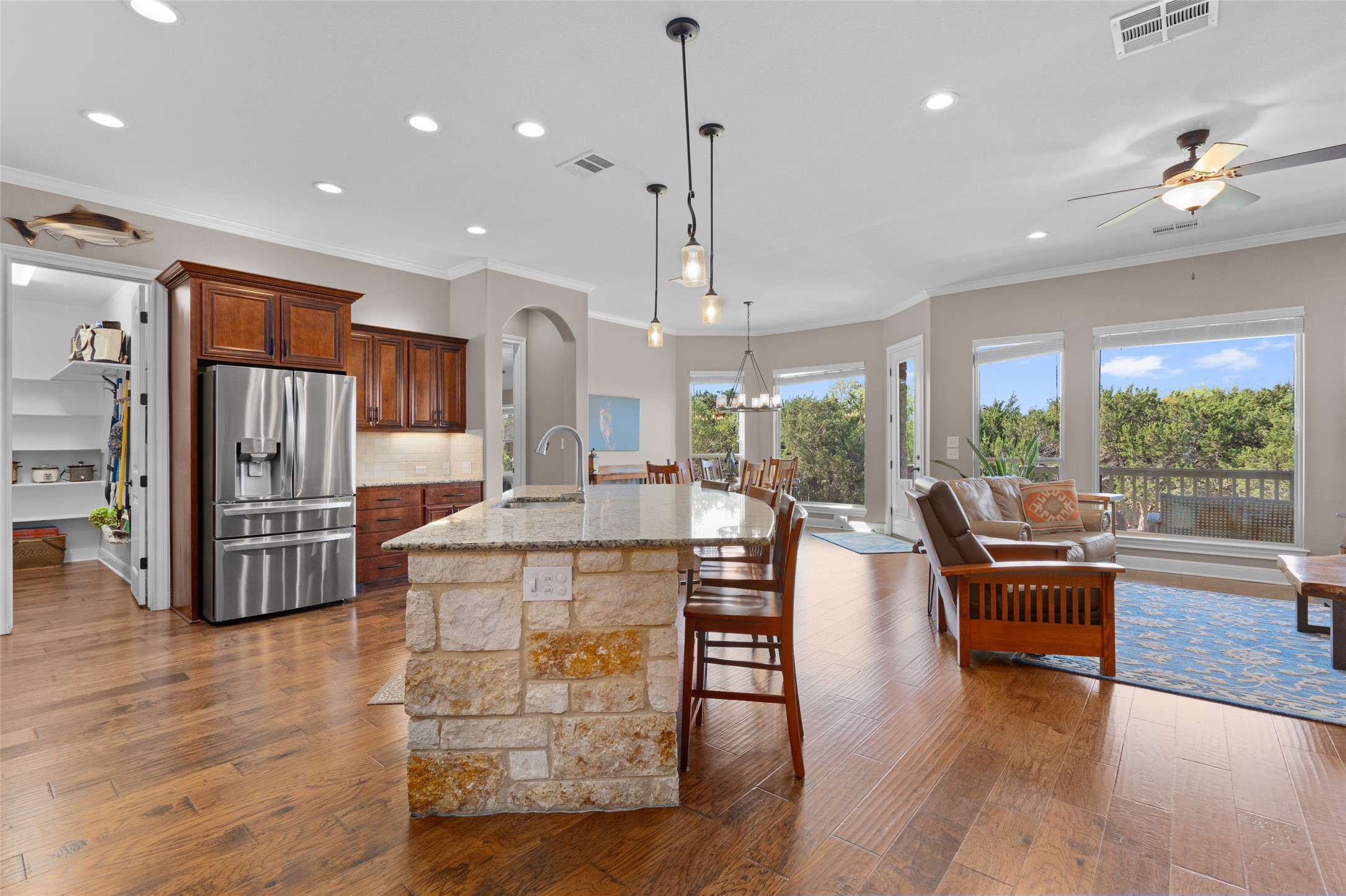 164 Milestone Road Liberty Hill, TX 78642 - Photo 39 of 40 Kitchen featuring stainless steel fridge, a breakfast bar, open floor plan, and a a large center island.