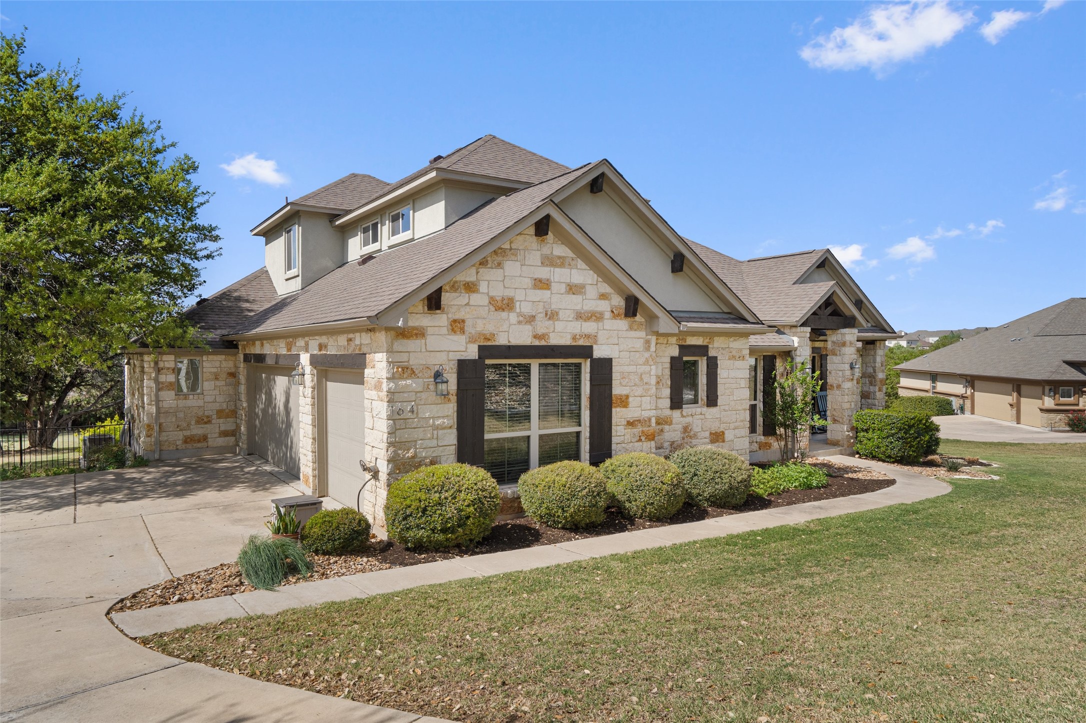 164 Milestone Road Liberty Hill, TX 78642 - Photo 3 of 40 The home has a side three car garage and plenty of parking on the oversized driveway.