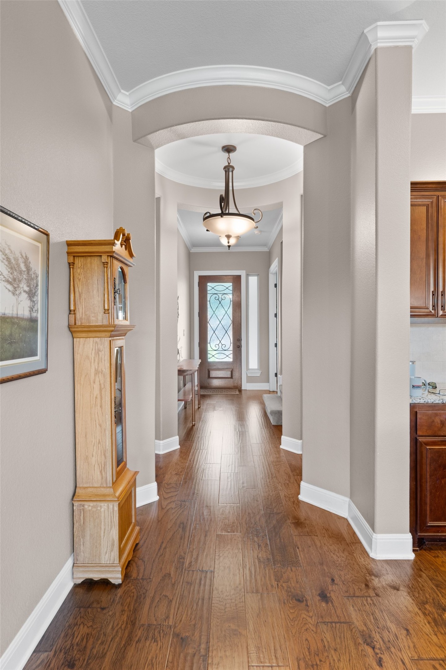 164 Milestone Road Liberty Hill, TX 78642 - Photo 5 of 40 This beautiful Foyer entrance featuring newer hard wood floors, crown molding, and arched walkways makes a grand statement