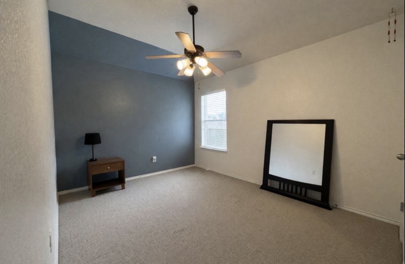 1052 Hot Spring Valley Buda, TX 78610 - Photo 25 of 36 Carpeted spare room featuring baseboards and ceiling fan