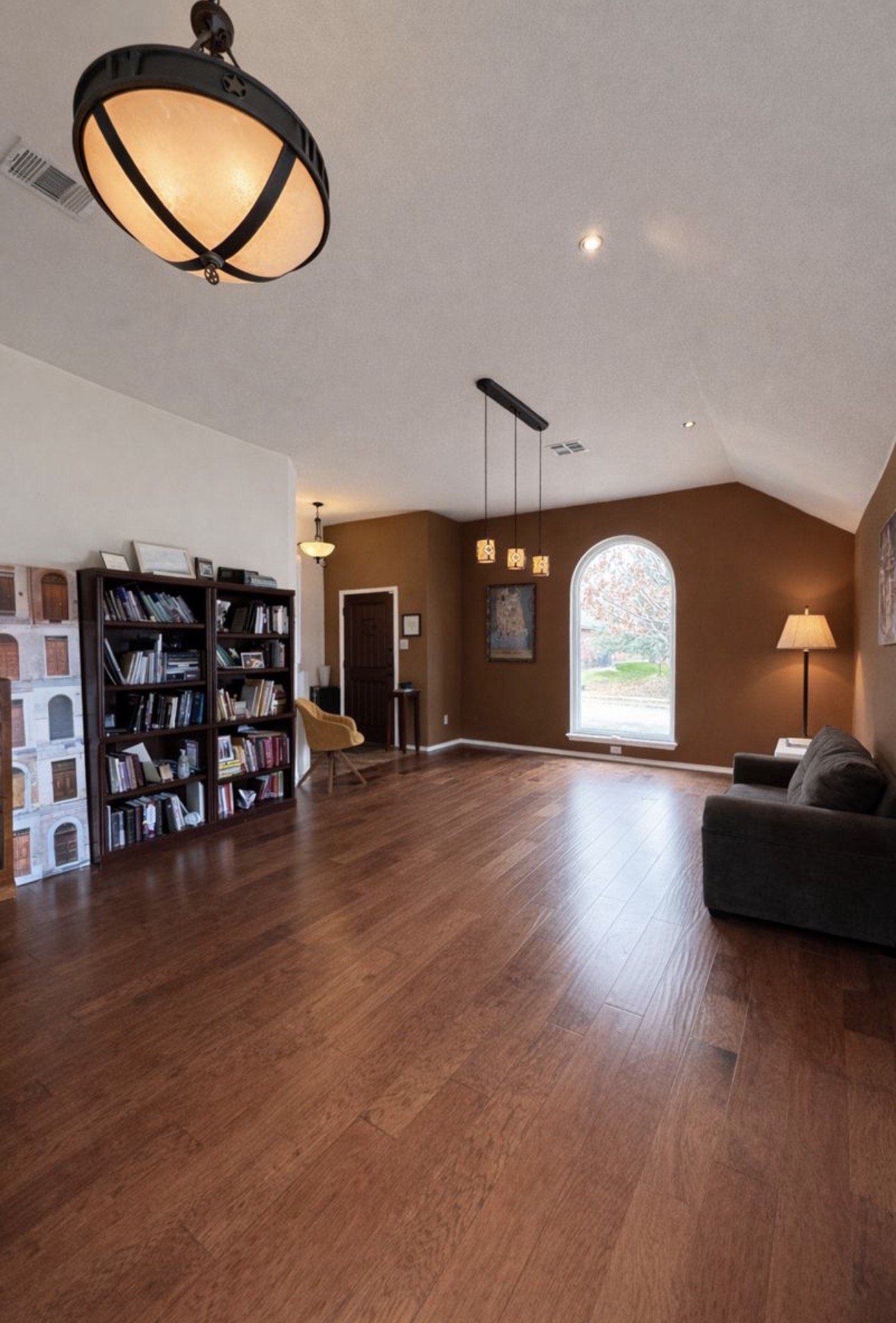 1052 Hot Spring Valley Buda, TX 78610 - Photo 4 of 36 Living room featuring dark wood-style flooring, lofted ceiling, and recessed lighting