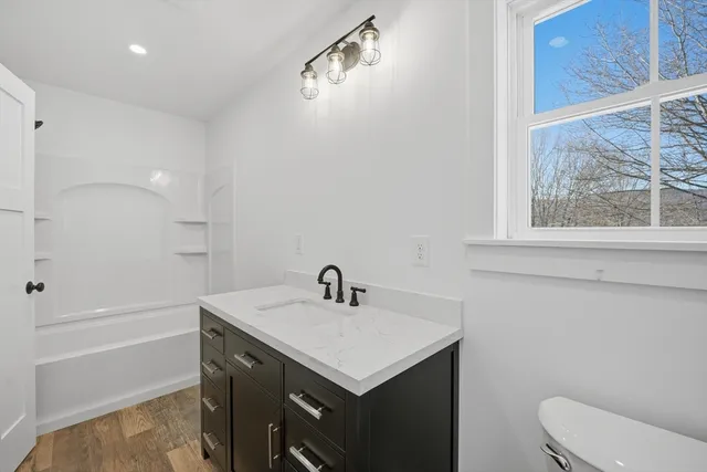 a bathroom with a sink toilet and shower