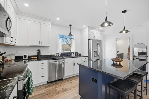 a kitchen with sink stove and cabinets