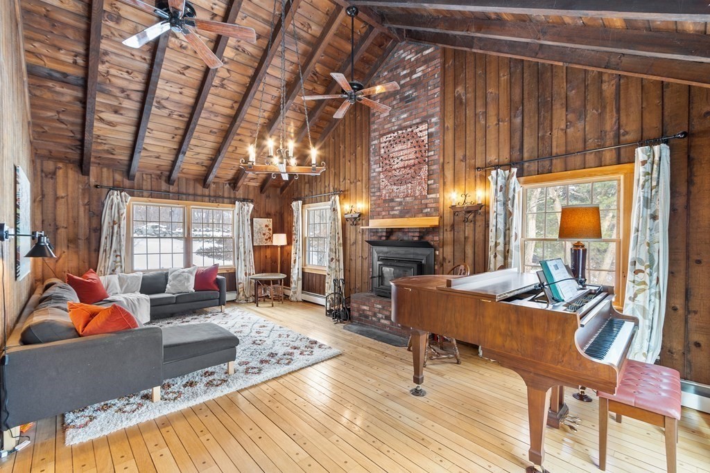 460 Littlefield Road Boxborough, MA 01719 - Photo 12 of 41 a living room with furniture a fireplace and large windows