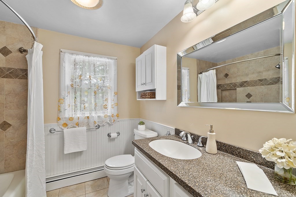 460 Littlefield Road Boxborough, MA 01719 - Photo 19 of 41 a bathroom with a granite countertop sink a toilet a mirror and shower