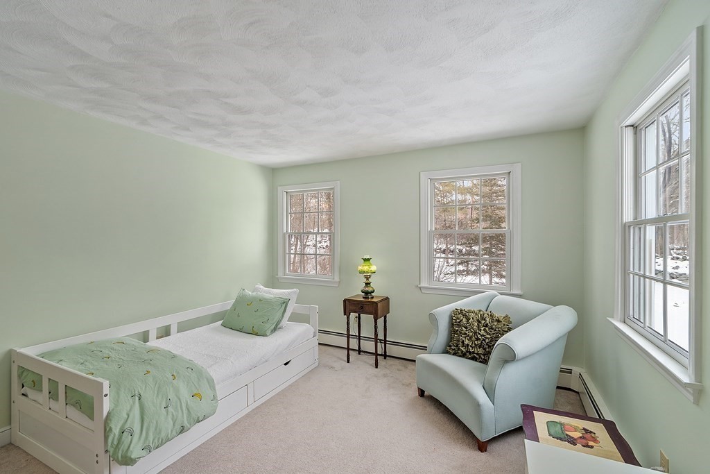 460 Littlefield Road Boxborough, MA 01719 - Photo 22 of 41 a spacious bedroom with a bed and a couch