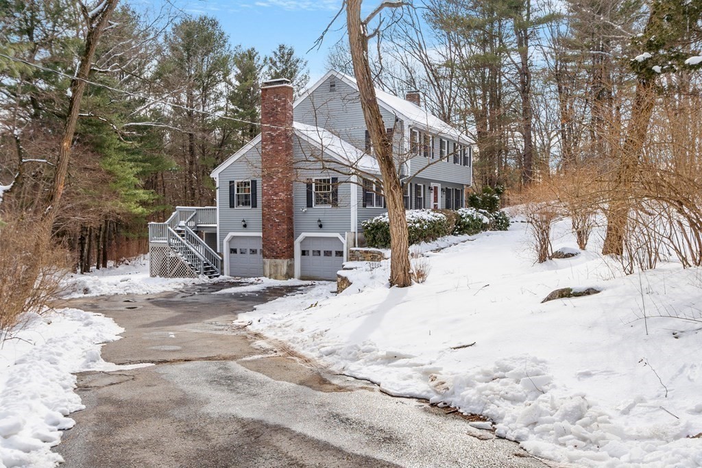 460 Littlefield Road Boxborough, MA 01719 - Photo 30 of 41 a front view of a house with a yard covered in snow