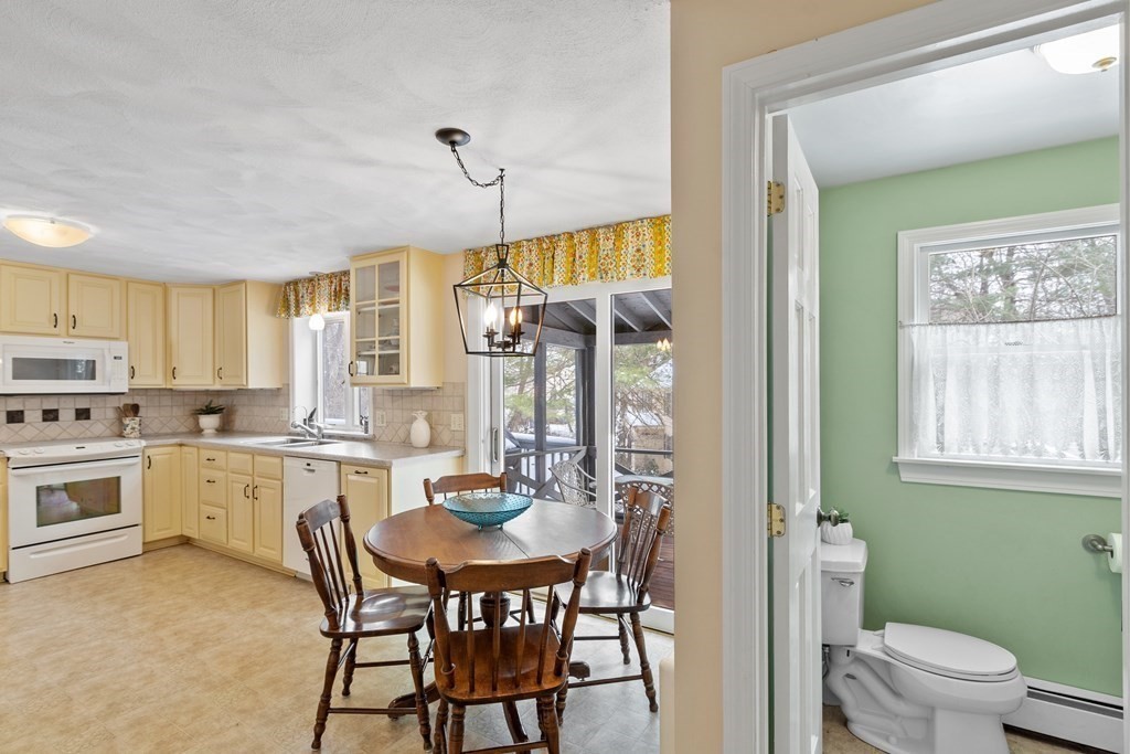 460 Littlefield Road Boxborough, MA 01719 - Photo 6 of 41 a kitchen with a table chairs sink and cabinets
