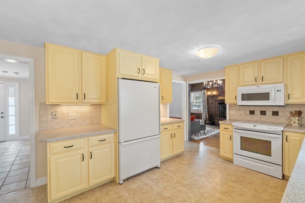 460 Littlefield Road Boxborough, MA 01719 - Photo 8 of 41 a kitchen with cabinets stainless steel appliances and wooden cabinets