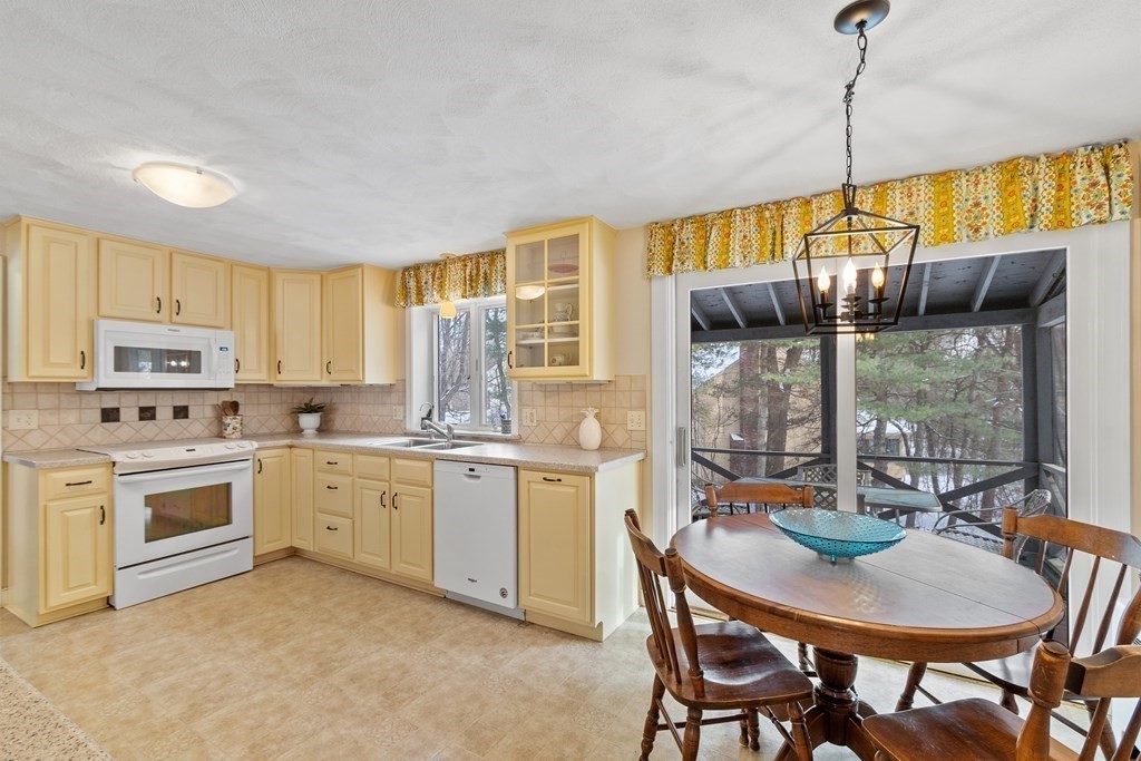 460 Littlefield Road Boxborough, MA 01719 - Photo 9 of 41 a kitchen with sink a stove and chairs