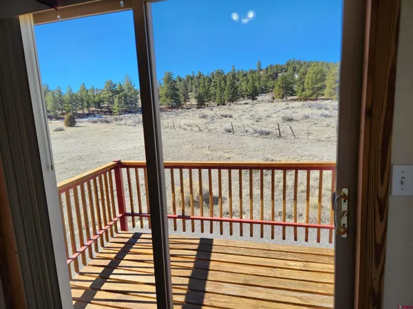 a view of a backyard with sitting area