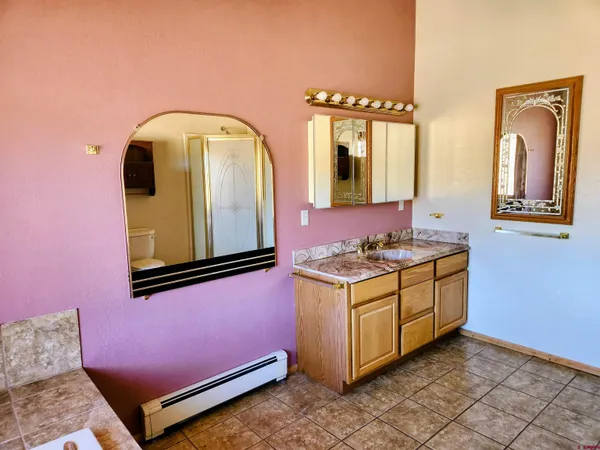 a bathroom with a sink a toilet and mirror