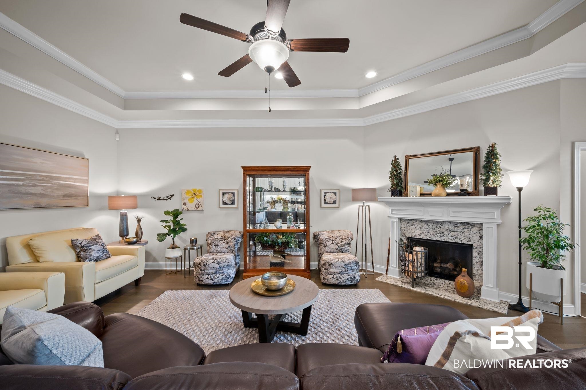 33842 Rutland Lane Spanish Fort, AL 36527 - Photo 2 of 42 Living area featuring baseboards, ornamental molding, ceiling fan, a fireplace, and wood finished floors