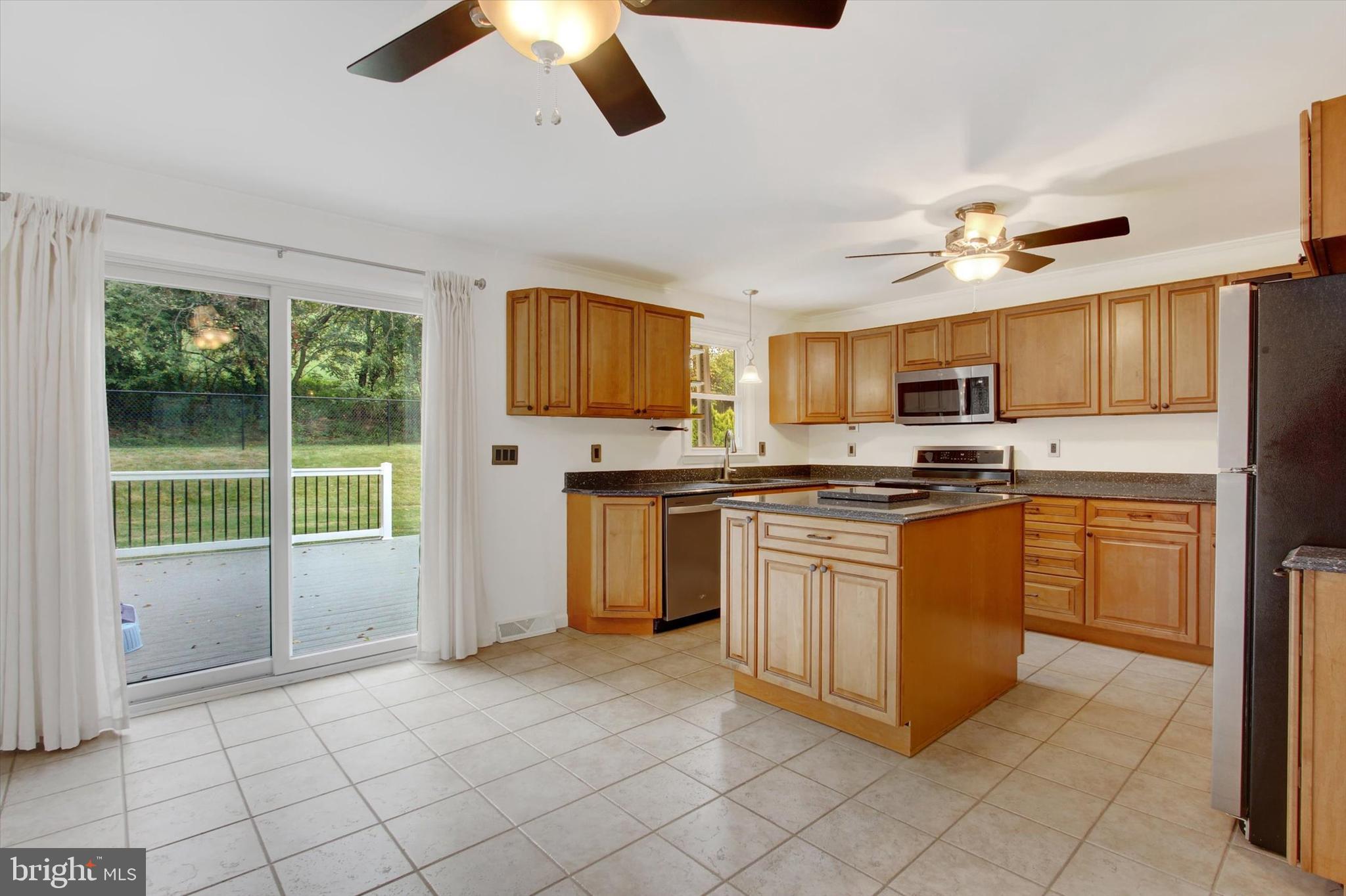 5206 Rockery Road Spring Grove, PA 17362 - Photo 13 of 28 a kitchen with granite countertop a stove top oven a sink dishwasher and a refrigerator