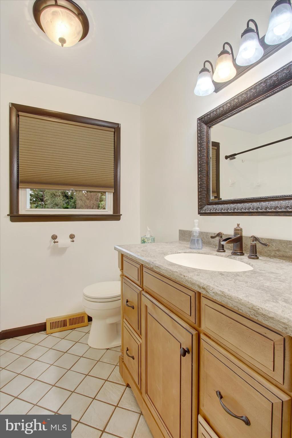 5206 Rockery Road Spring Grove, PA 17362 - Photo 21 of 28 a bathroom with a granite countertop toilet sink and mirror