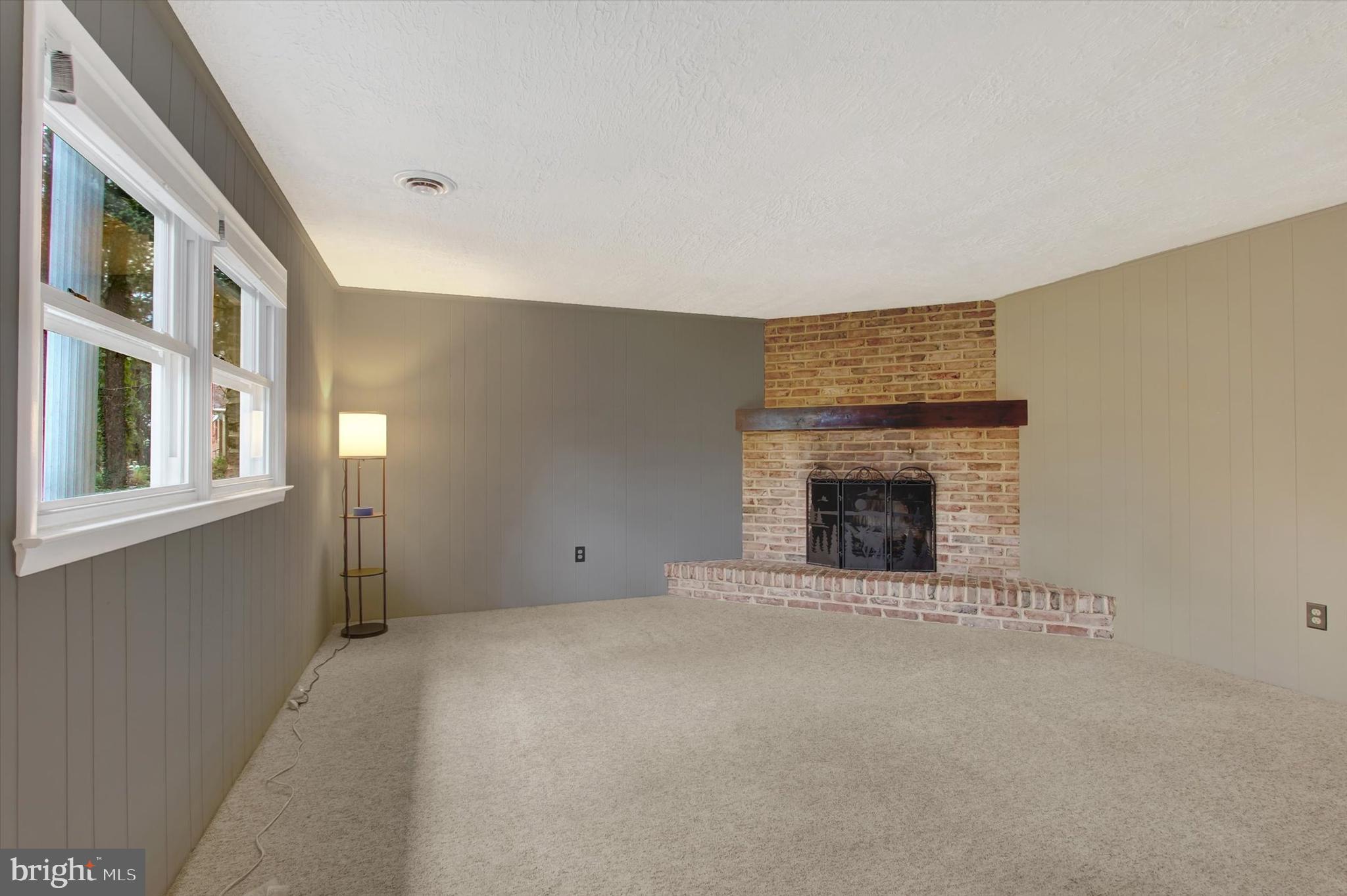 5206 Rockery Road Spring Grove, PA 17362 - Photo 6 of 28 a view of an empty room with a fireplace and a window