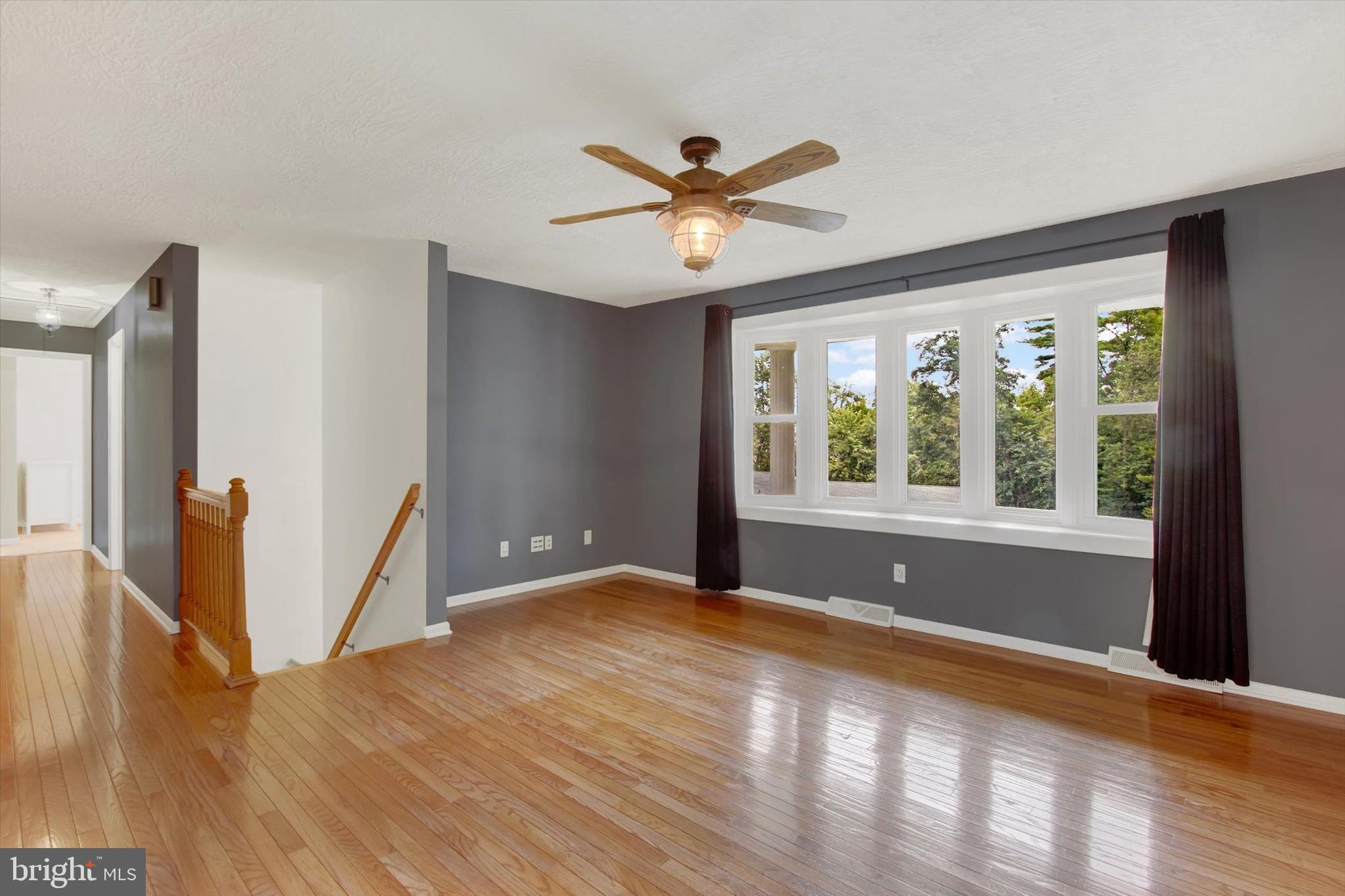 5206 Rockery Road Spring Grove, PA 17362 - Photo 10 of 28 a view of an empty room with window and wooden floor