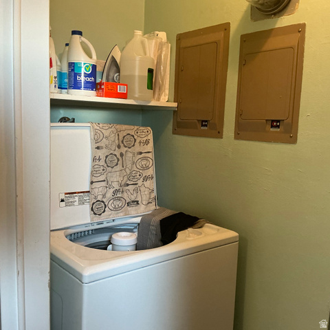98 Main Street Manila, UT 84046 - Photo 13 of 36 Dedicated laundry area featuring a white top-load washing machine, an overhead shelf, and two wall-mounted utility panels