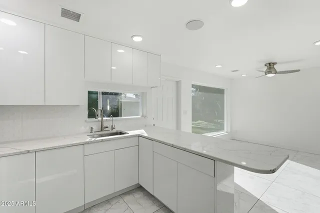 a kitchen with a sink cabinets and window