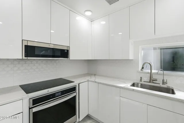 a kitchen with a sink and cabinets