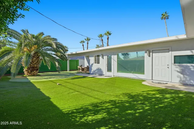 a view of a house with backyard porch and sitting area