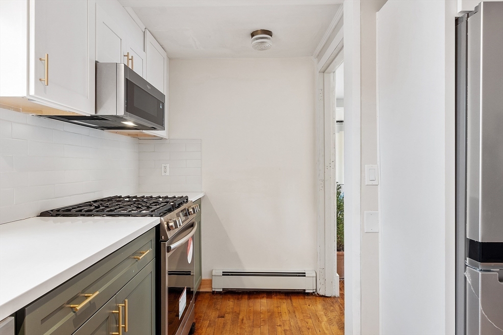 24 Myrtle Avenue Wakefield, MA 01880 - Photo 12 of 39 a kitchen with a stove and a microwave