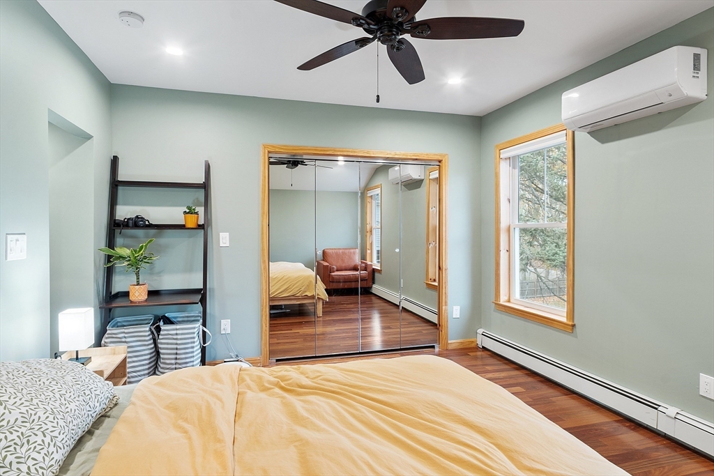 24 Myrtle Avenue Wakefield, MA 01880 - Photo 19 of 39 a bedroom with a bed and a chandelier