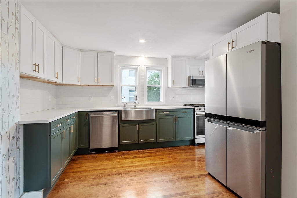 24 Myrtle Avenue Wakefield, MA 01880 - Photo 10 of 39 a kitchen with a refrigerator sink and cabinets