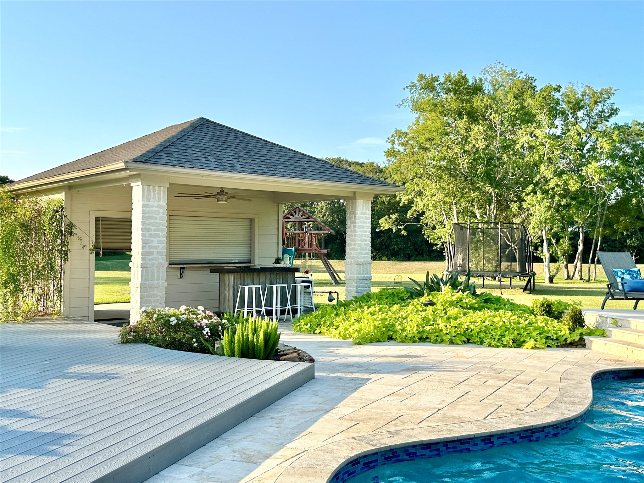 2904 Bridle Path Lane Friendswood, TX 77546 - Photo 44 of 49 The inviting pool house offers a serving window and a full back garage door, providing ample space to store all your outdoor essentials. With room for a fridge, ice machine, and more, it’s perfectly equipped for fun-filled days and effortless backyard entertaining.