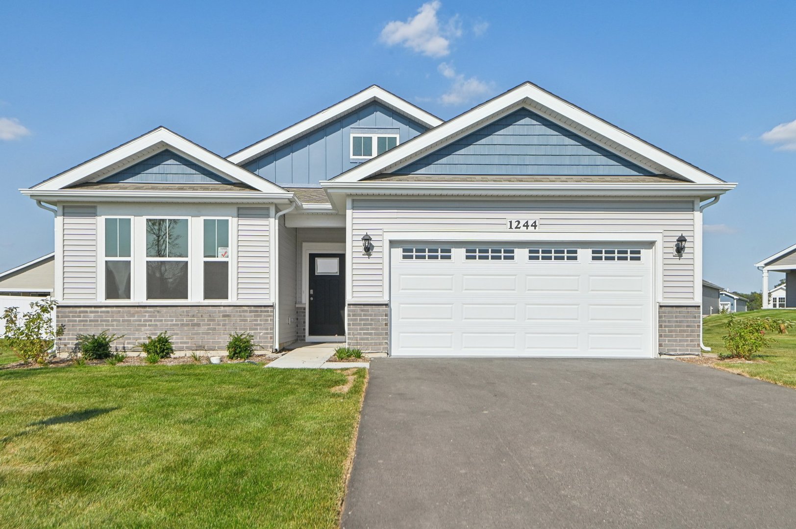 a front view of a house with a yard and garage