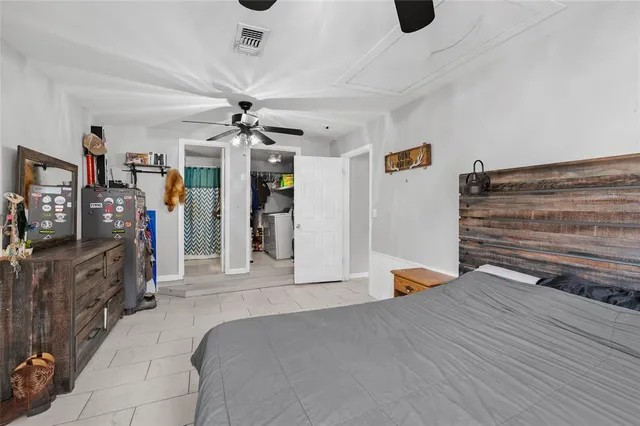 a bedroom with furniture and a ceiling fan