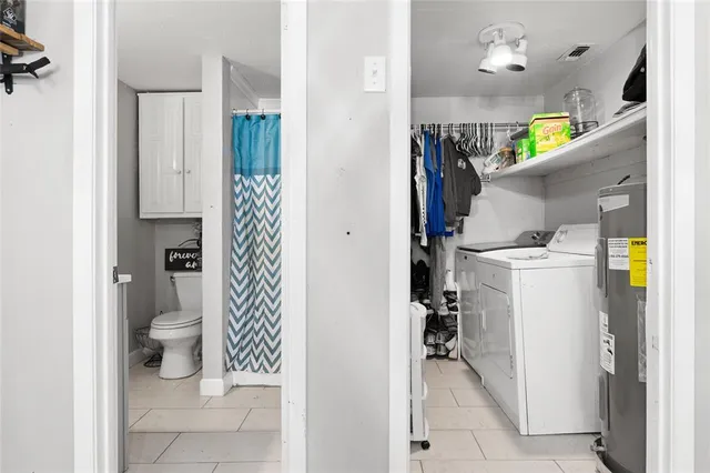 a bathroom with a toilet and a shower curtain