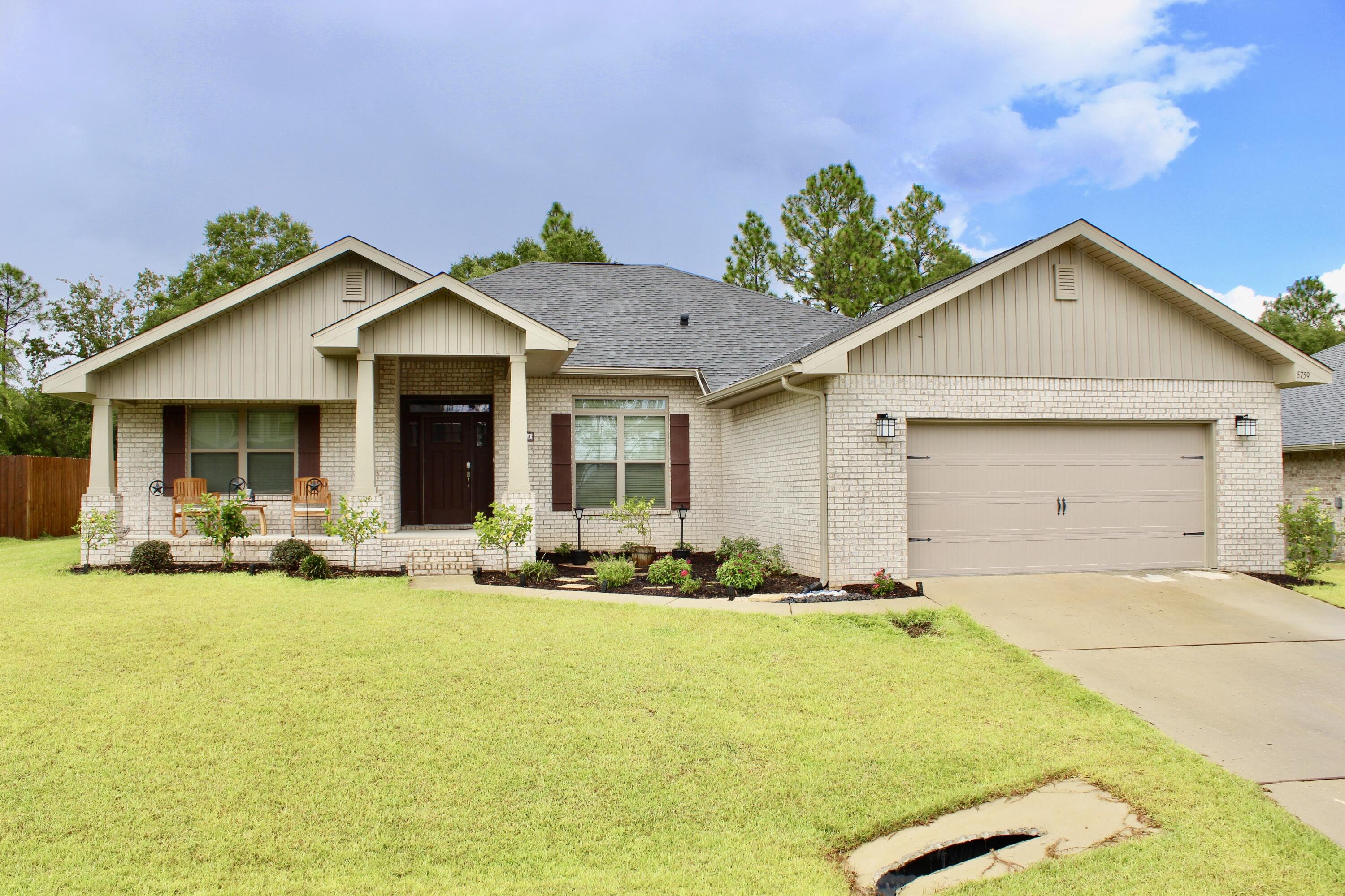 5759 Marigold Loop Crestview, FL 32539 - Photo 1 of 29 a front view of house with yard outdoor seating and barbeque oven