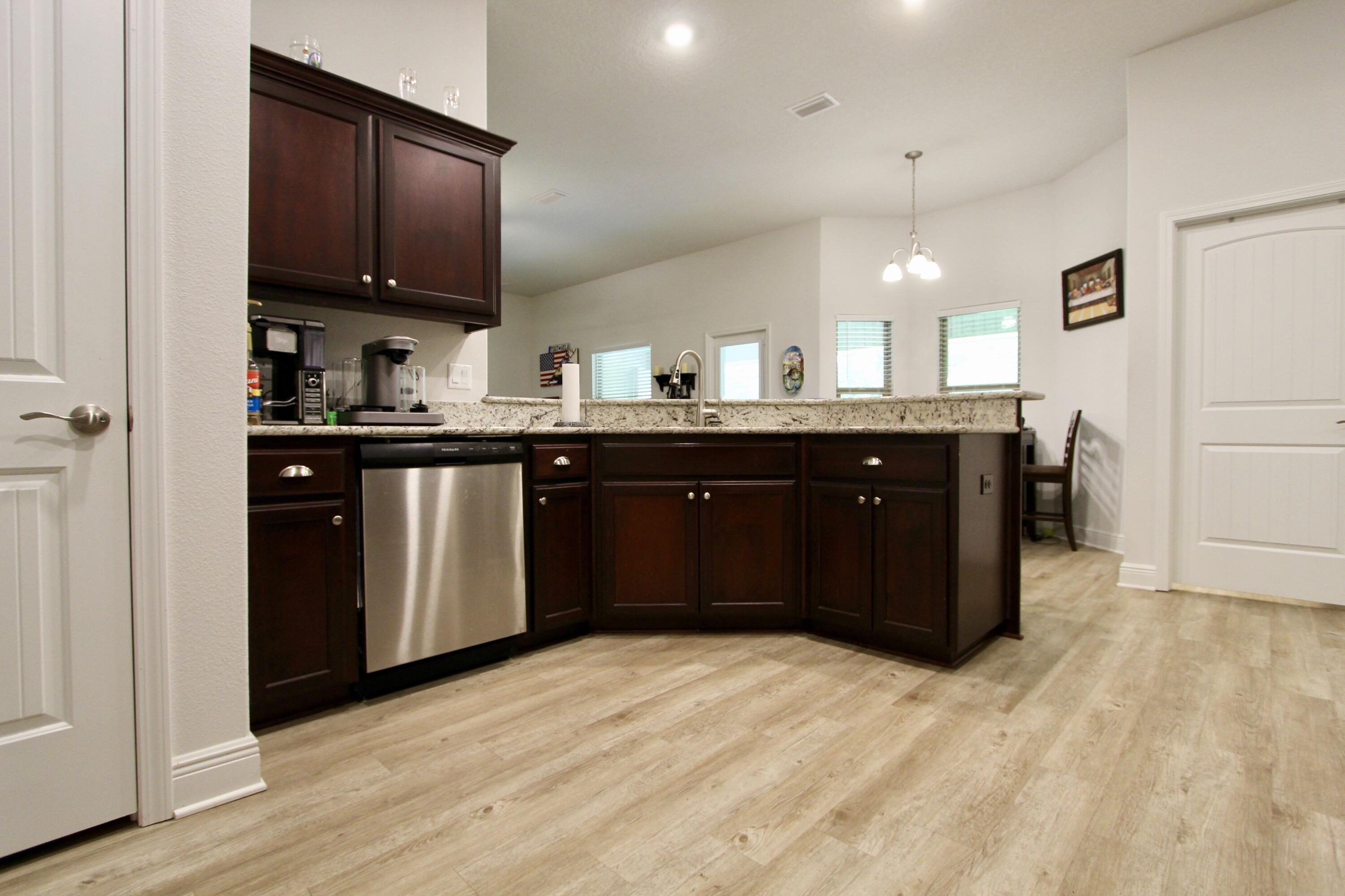 5759 Marigold Loop Crestview, FL 32539 - Photo 11 of 29 a kitchen with a sink and wooden cabinets