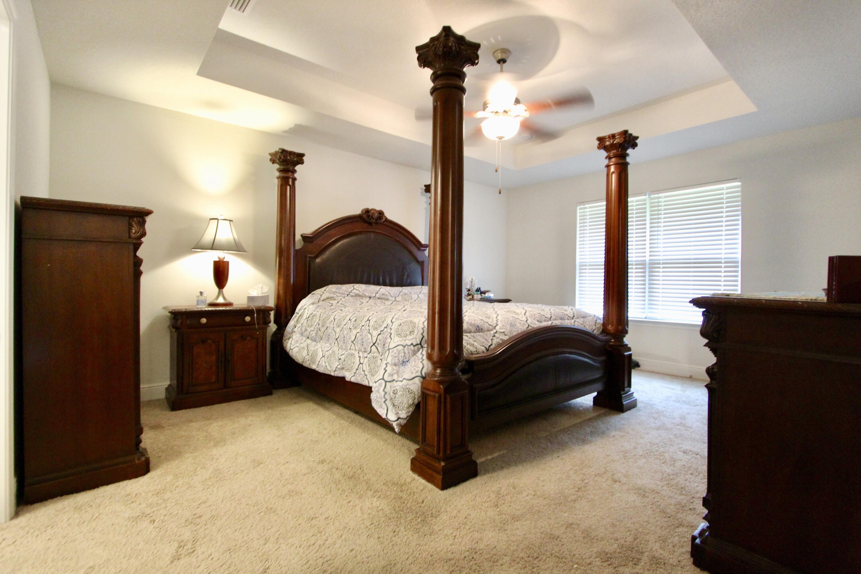 5759 Marigold Loop Crestview, FL 32539 - Photo 17 of 29 a bedroom with a bed lamp and a dresser