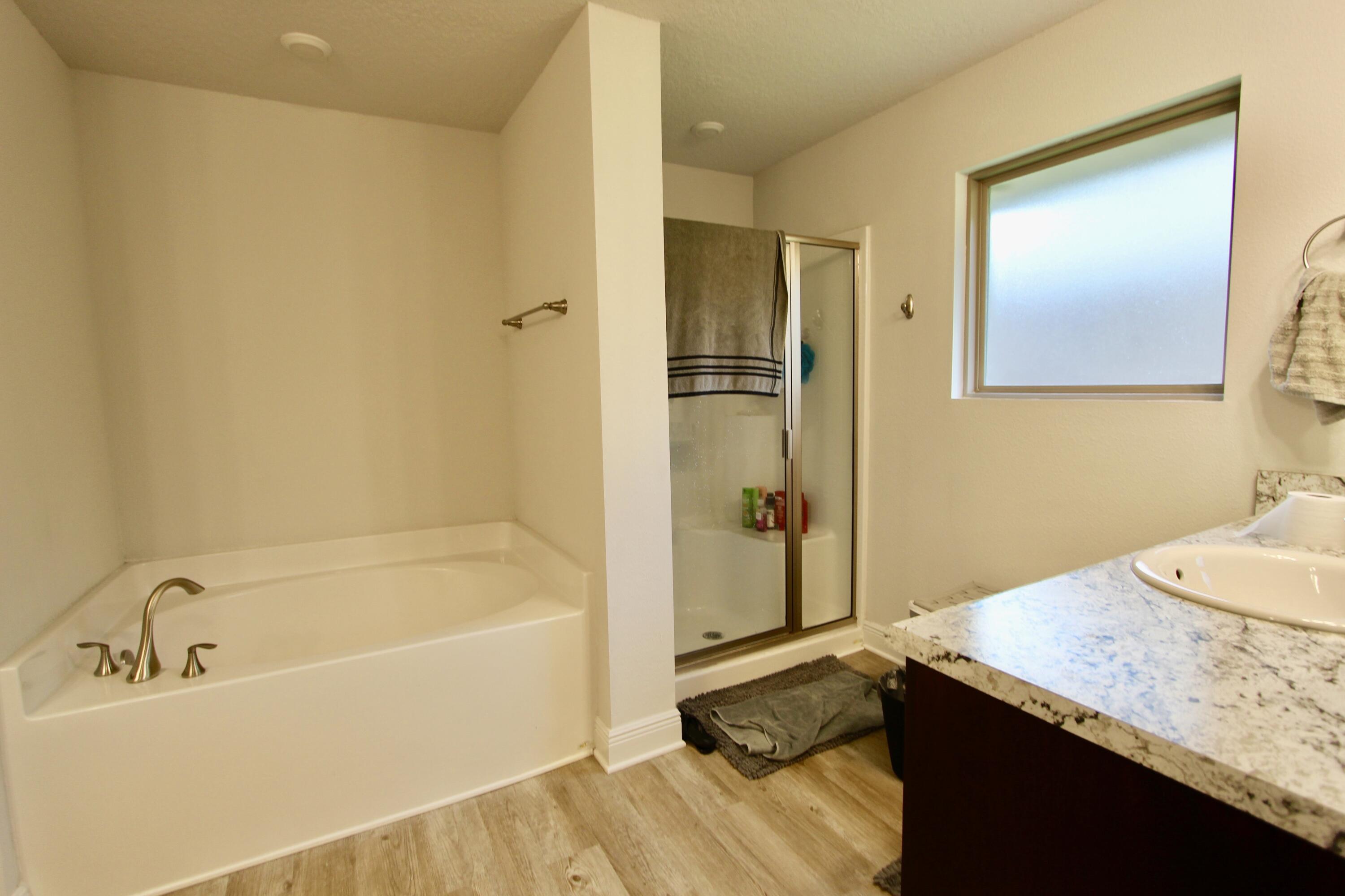 5759 Marigold Loop Crestview, FL 32539 - Photo 18 of 29 a bathroom with a granite countertop sink and a bathtub
