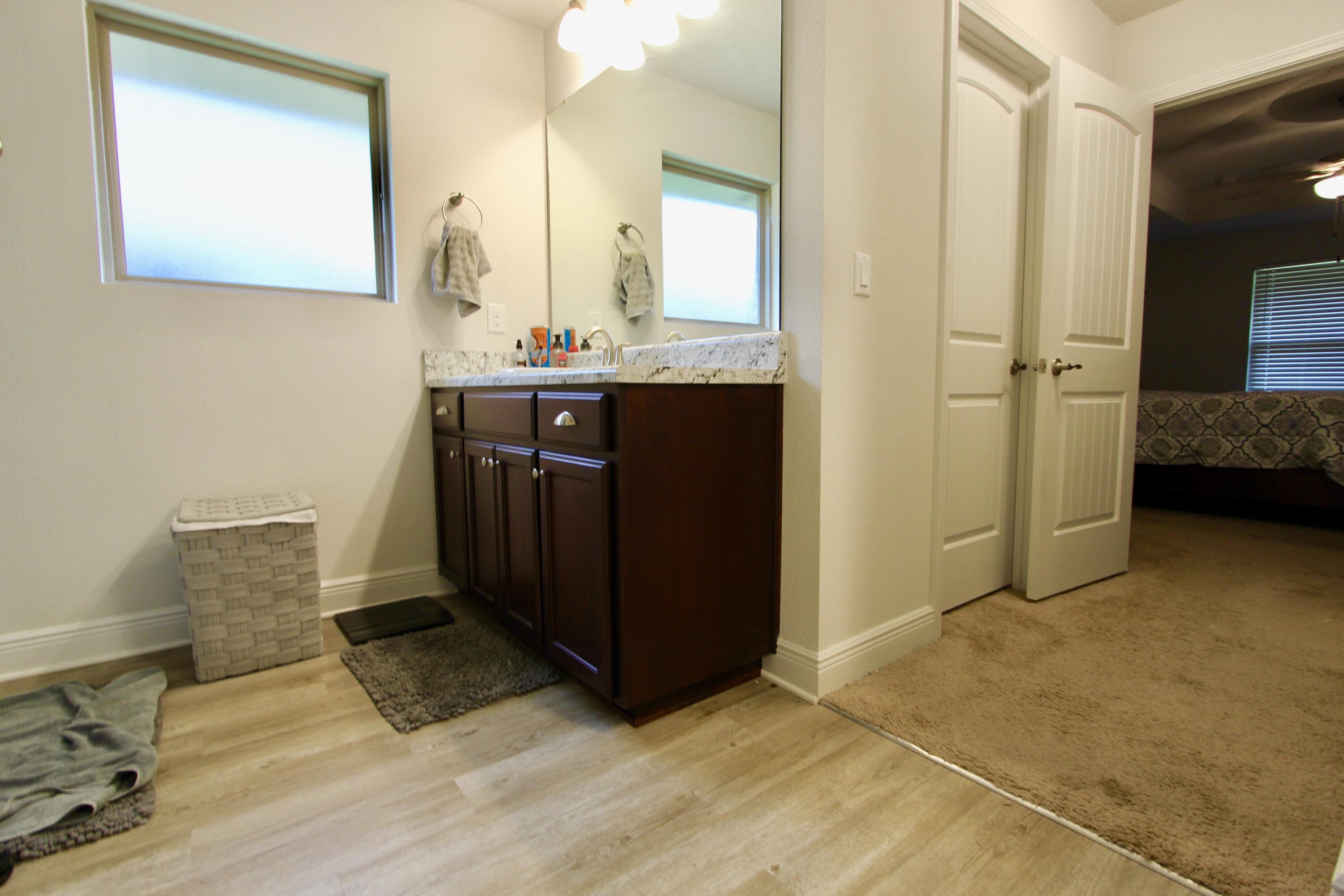 5759 Marigold Loop Crestview, FL 32539 - Photo 19 of 29 a en suite bathroom with a sink and a mirror