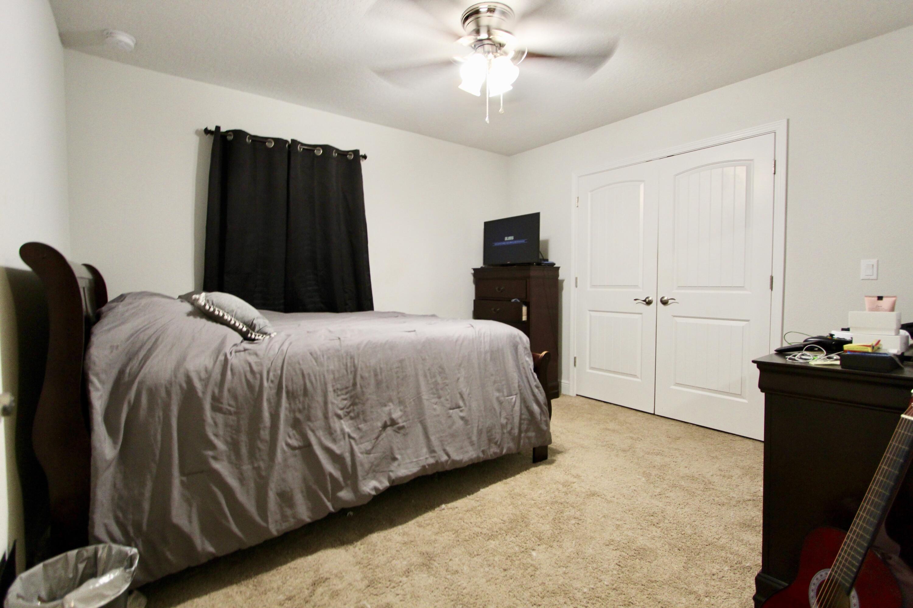 5759 Marigold Loop Crestview, FL 32539 - Photo 21 of 29 a bedroom with a bed and a television