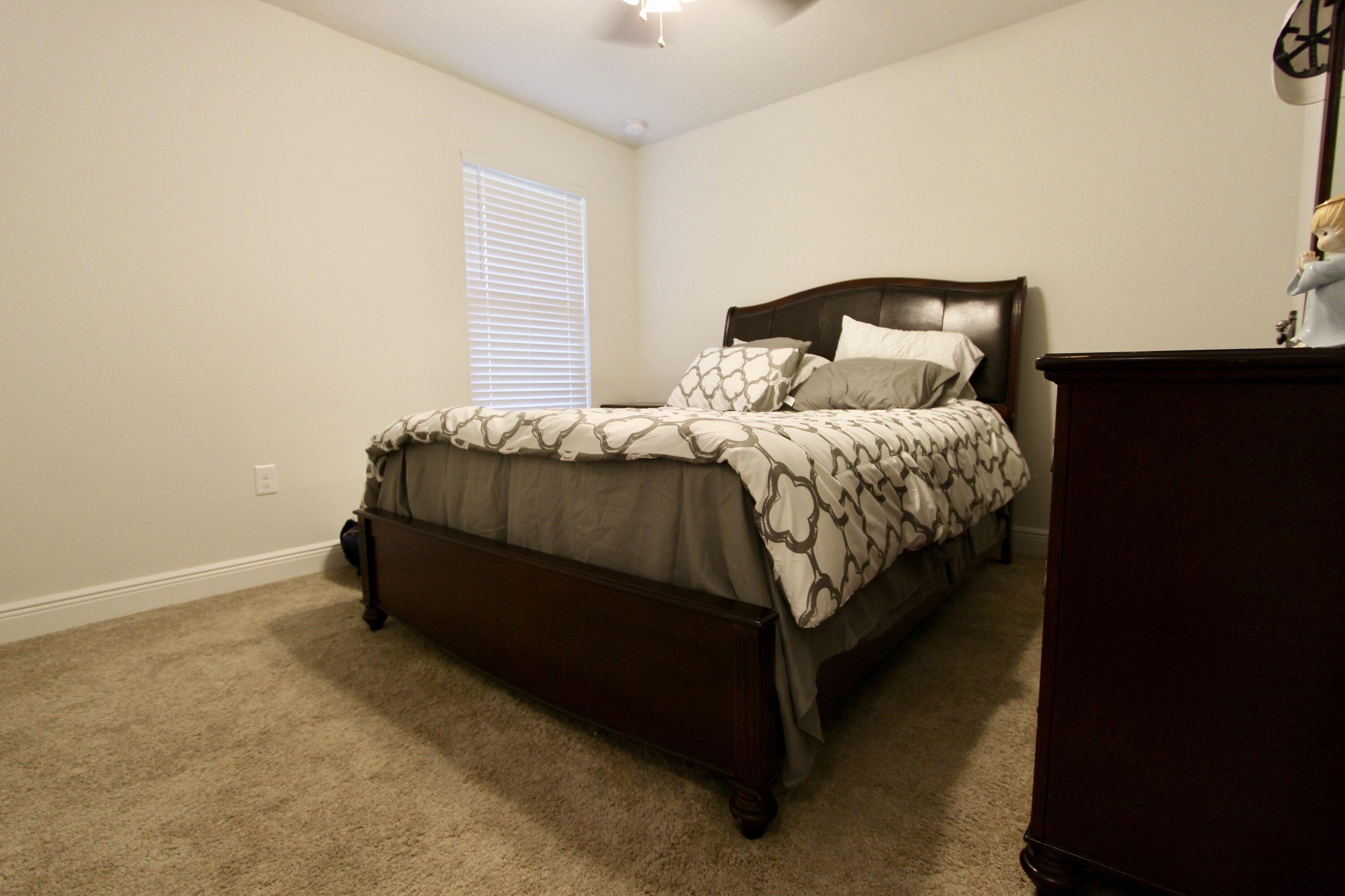 5759 Marigold Loop Crestview, FL 32539 - Photo 23 of 29 a bedroom with a bed and window
