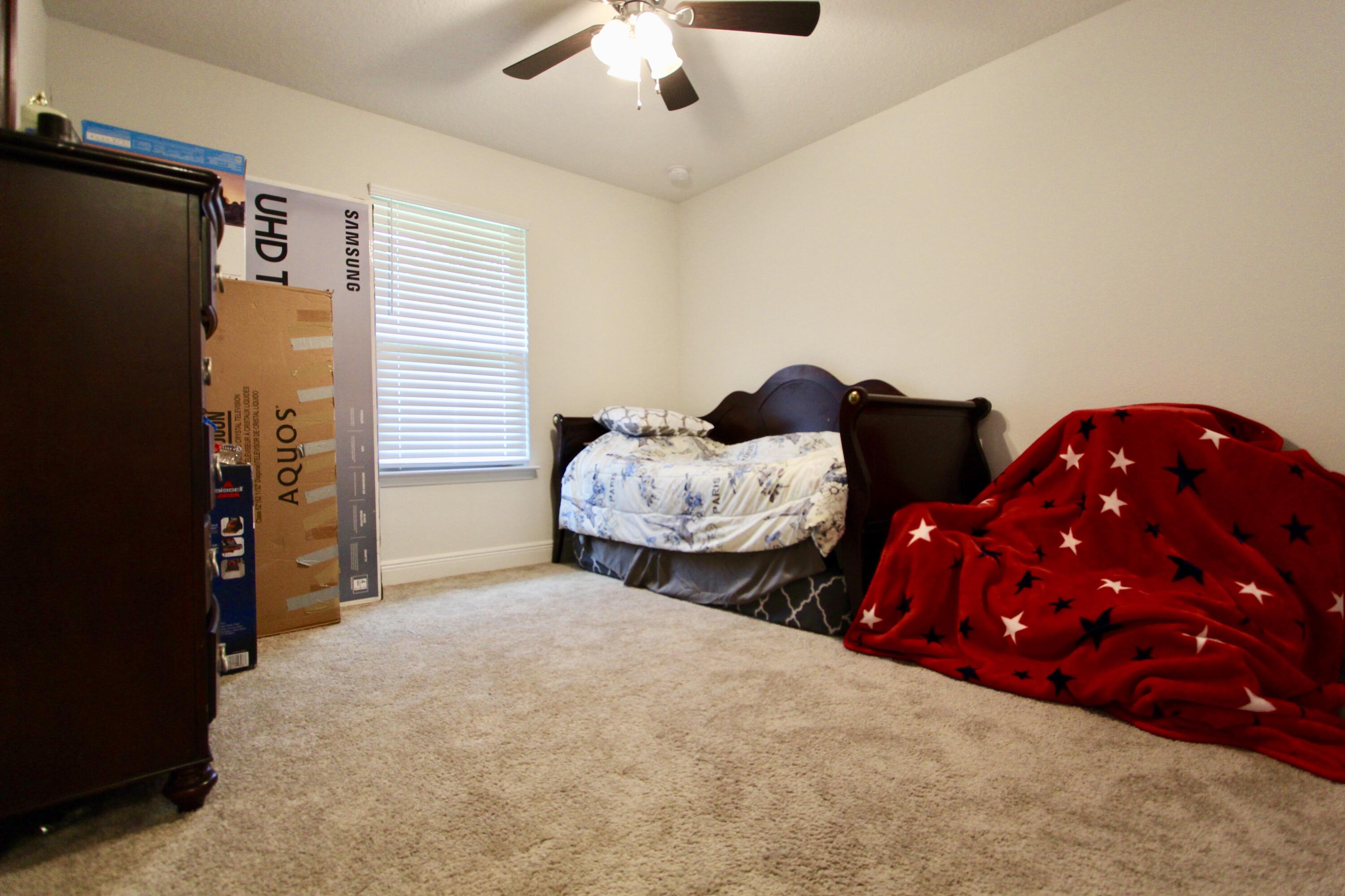 5759 Marigold Loop Crestview, FL 32539 - Photo 24 of 29 a bedroom with bed and a chandelier