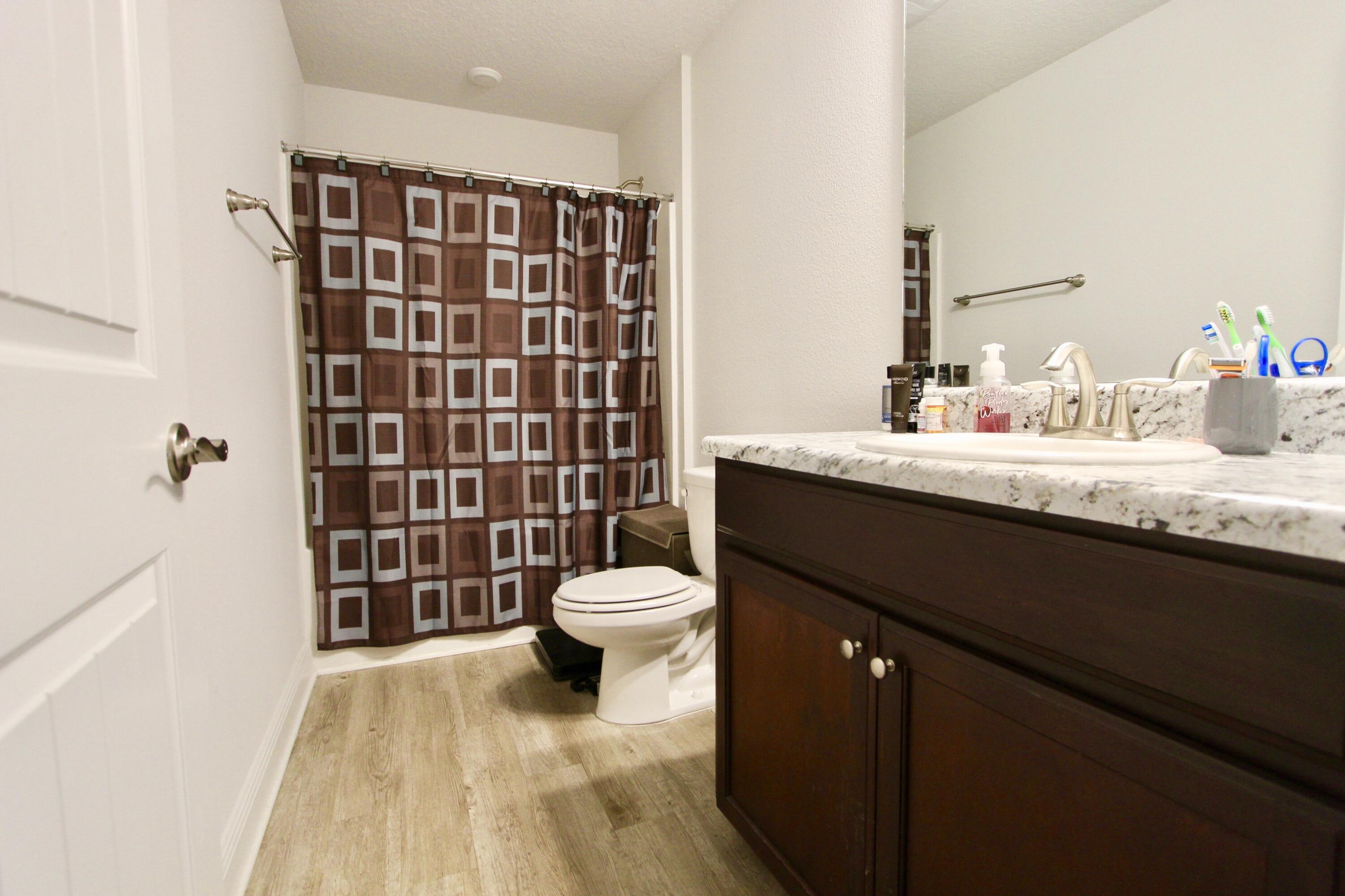 5759 Marigold Loop Crestview, FL 32539 - Photo 25 of 29 a bathroom with a sink a toilet a shower and a mirror