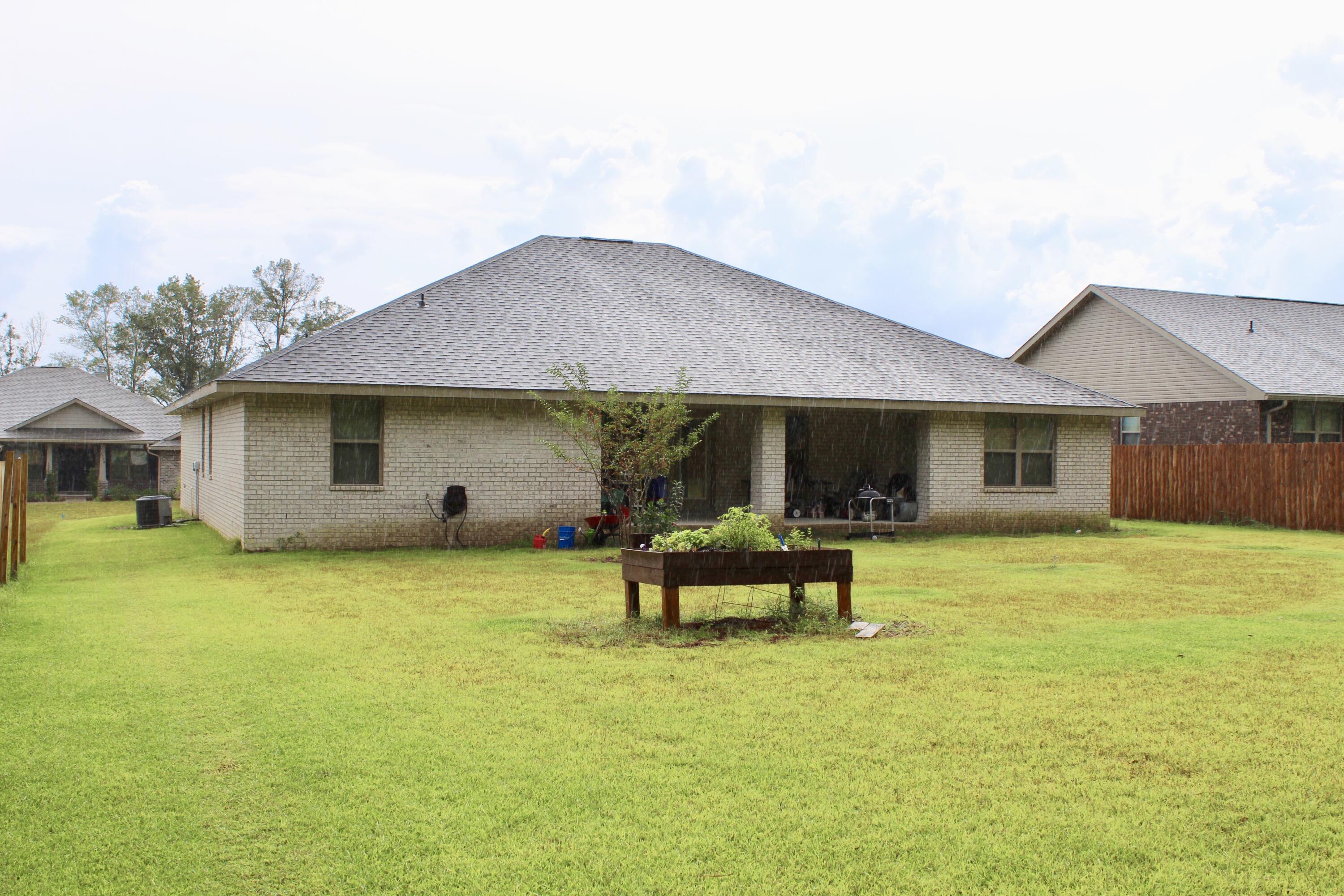 5759 Marigold Loop Crestview, FL 32539 - Photo 28 of 29 a backyard of a house with table and chairs