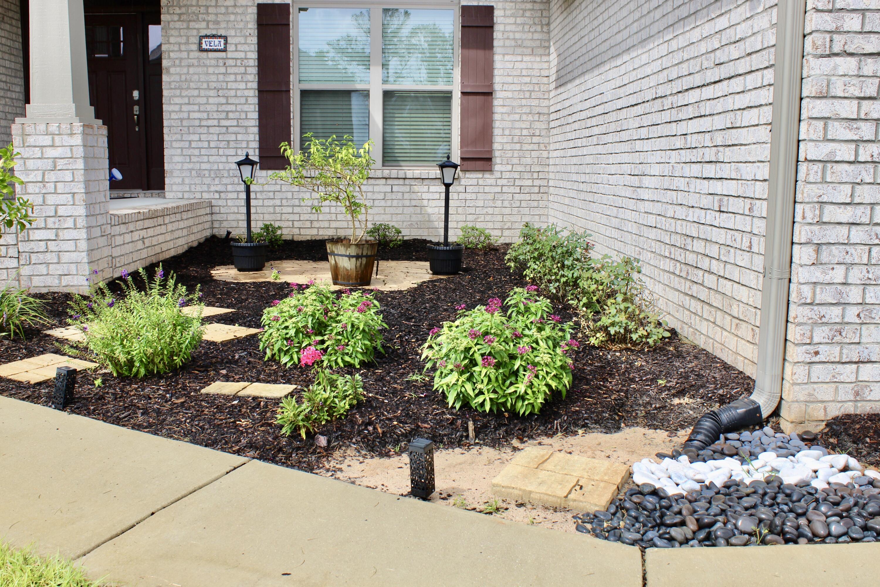 5759 Marigold Loop Crestview, FL 32539 - Photo 5 of 29 a view of a pathway of the house with potted plants