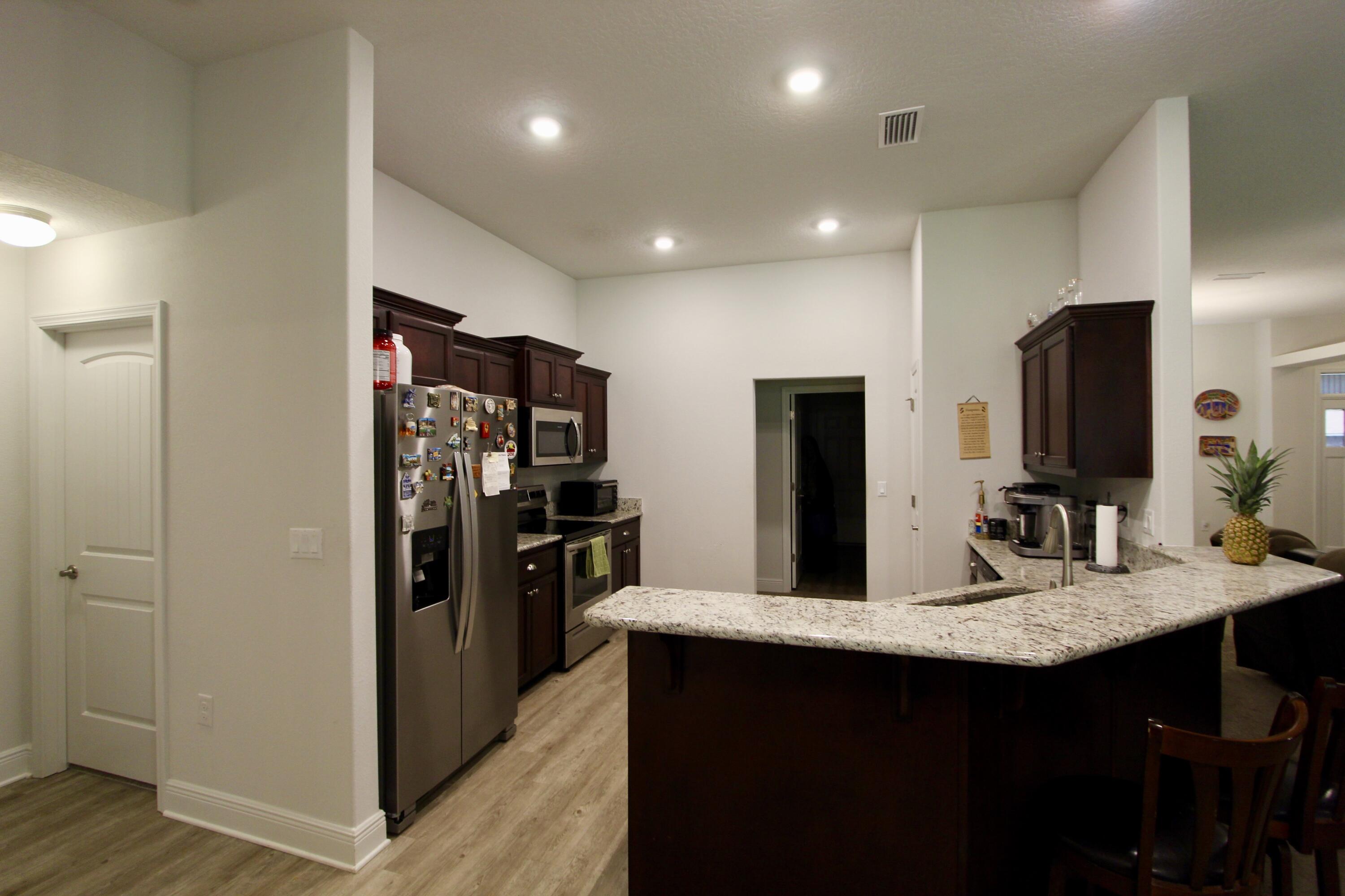 5759 Marigold Loop Crestview, FL 32539 - Photo 9 of 29 a kitchen with stainless steel appliances granite countertop a refrigerator and a sink